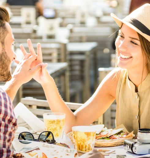 Coppia felice al ristorante con cibo e bevande.